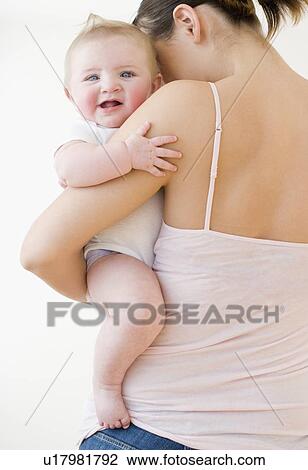 Stock Image - Mother holding baby. Fotosearch
