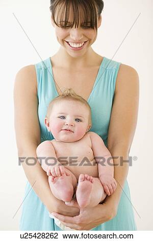 Stock Image - Mother holding baby. Fotosearch