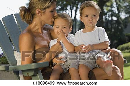 Stock Photo - Mother holding twin toddler sons. Fotosearch