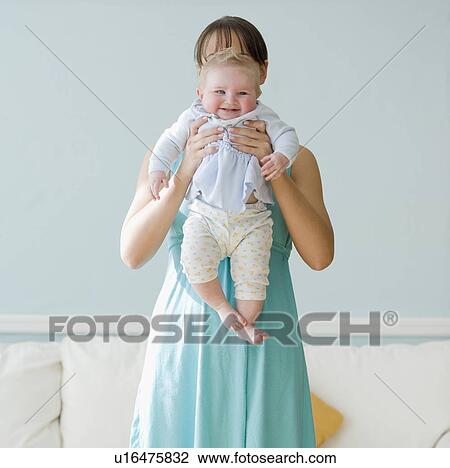 Mother holding up baby View Large Photo Image Stock Image - Mother holding up baby. Fotosearch