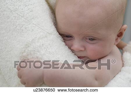 Stock Image - Mother hugging baby boy. Fotosearch