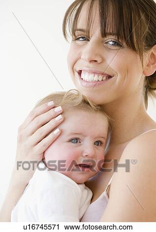 Stock Image - Mother hugging baby. Fotosearch