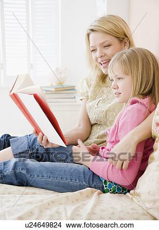 Mother reading to daughter View Large Photo Image Picture - Mother reading to daughter. Fotosearch