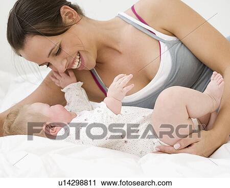 Stock Image - Mother smiling at baby. Fotosearch