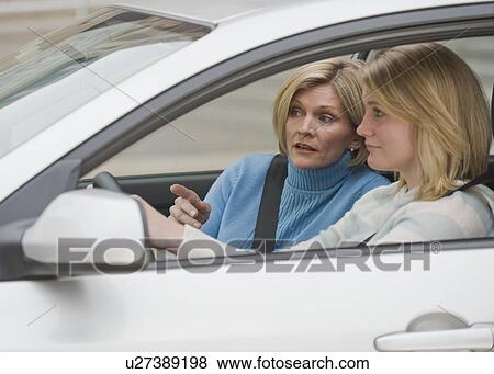 Mother teaching teenaged daughter to drive View Large Photo Image Stock Photo - Mother teaching teenaged daughter to drive. Fotosearch