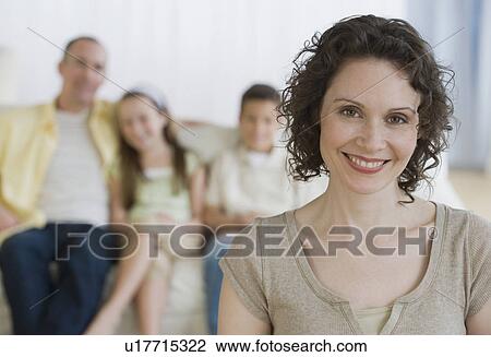 Stock Image - Mother with family in background. Fotosearch