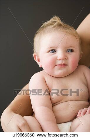 Stock Image - Mother’s arm around baby. Fotosearch