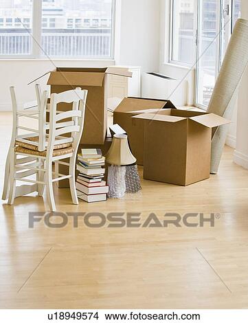 Moving boxes and chairs in livingroom View Large Photo Image Picture - Moving boxes and chairs in livingroom. Fotosearch