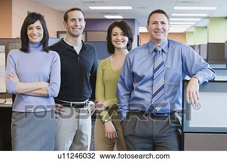 Multi-ethnic businesspeople standing in office View Large Photo Image Stock Image - Multi-ethnic businesspeople standing in office. Fotosearch