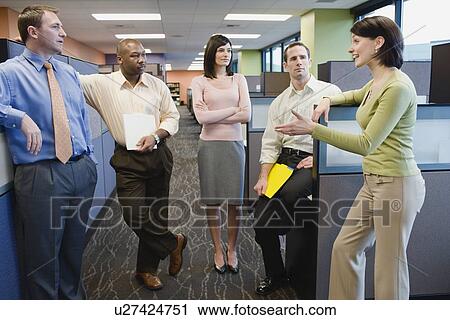 Multi-ethnic businesspeople talking in hallway View Large Photo Image Stock Image - Multi-ethnic businesspeople talking in hallway. Fotosearch