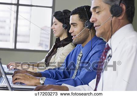 Multi-ethnic businesspeople wearing headsets View Large Photo Image Stock Image - Multi-ethnic businesspeople wearing headsets. Fotosearch