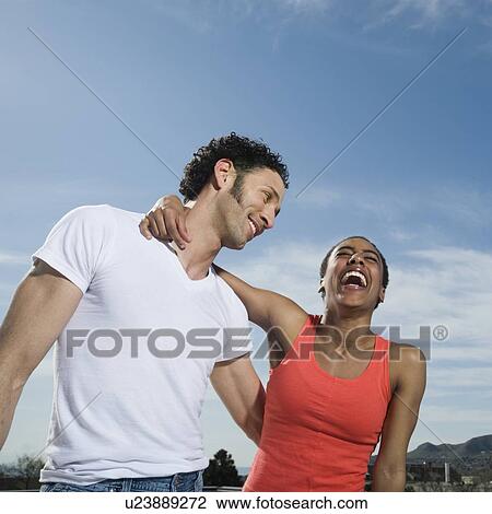 Stock Image - Multi-ethnic couple laughing. Fotosearch