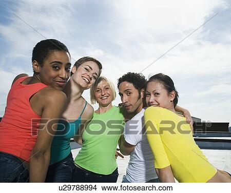 Picture - Multi-ethnic friends hugging. Fotosearch