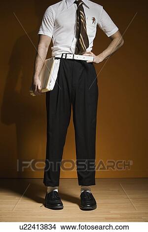 Nerdy man holding school books View Large Photo Image Picture - Nerdy man holding school books. Fotosearch