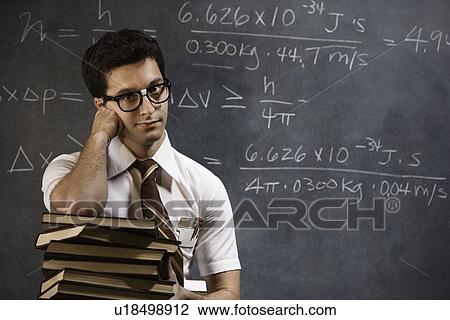 Nerdy man in front of blackboard View Large Photo Image Stock Image - Nerdy man in front of blackboard. Fotosearch