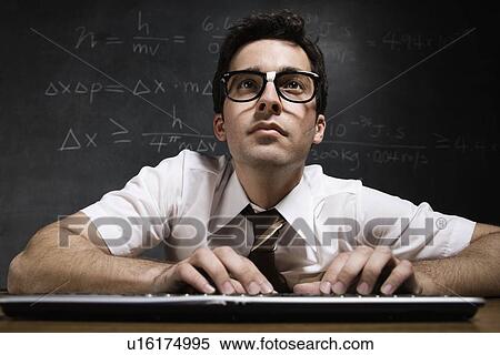 Nerdy man in front of blackboard View Large Photo Image Stock Photography - Nerdy man in front of blackboard. Fotosearch