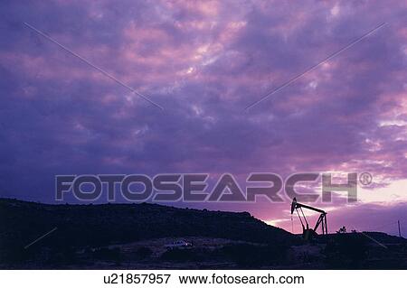 Oil rig in distance under sunset sky View Large Photo Image Stock Photo - Oil rig in distance under sunset sky. Fotosearch