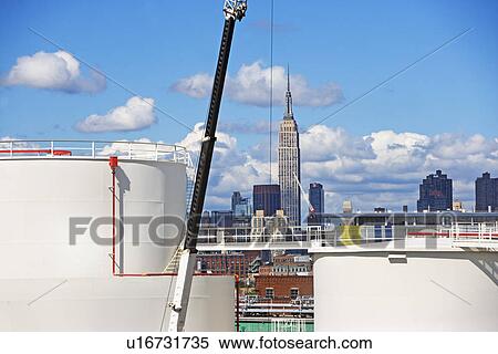 Stock Photography - Oil storage tanks with New York City in background. Fotosearch