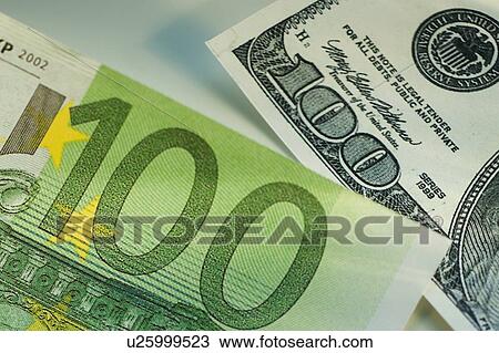 Stock Image - One hundred dollar bill and one hundred euro bill. Fotosearch