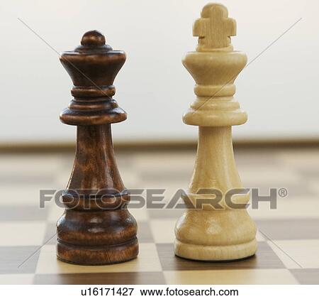 Opposing king and queen chess pieces View Large Photo Image Stock Photo - Opposing king and queen chess pieces. Fotosearch