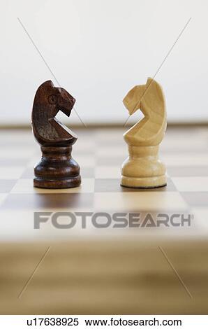 Stock Photography - Opposing knight chess pieces. Fotosearch