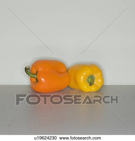 Orange and yellow bell peppers on table View Large Photo Image Stock Image - Orange and yellow bell peppers on table. Fotosearch