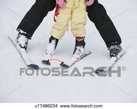 Picture - Parent and child skiing. Fotosearch