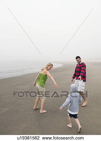 Parents and son on beach View Large Photo Image Stock Image - Parents and son on beach. Fotosearch