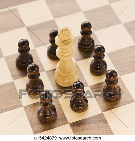 Pawns surrounding king on chessboard View Large Photo Image Stock Photo - Pawns surrounding king on chessboard. Fotosearch