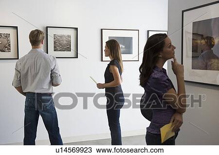 People looking at pictures in art gallery View Large Photo Image Stock Image - People looking at pictures in art gallery. Fotosearch
