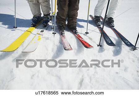 Stock Photography - People standing on skis. Fotosearch
