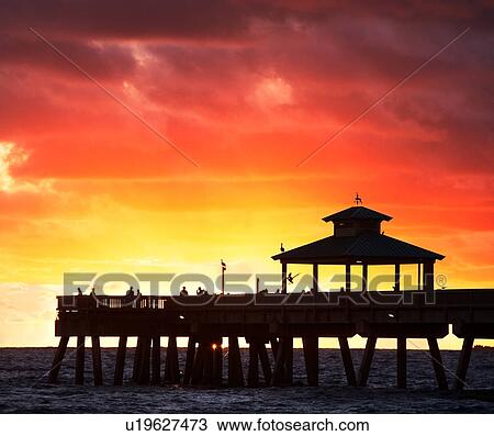 Stock Image - pier in the sunset/sunrise. Fotosearch