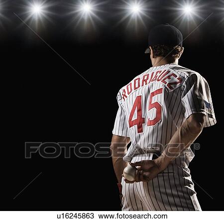 Pitcher holding baseball behind back View Large Photo Image Stock Image - Pitcher holding baseball behind back. Fotosearch