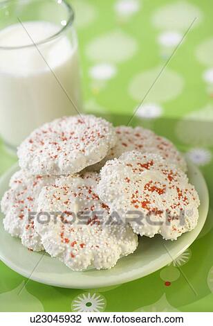 Stock Image - Plate of cookies next to glass of milk. Fotosearch