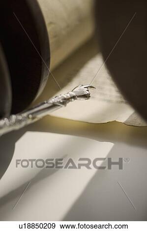 Stock Photo - Pointer pointing to Torah scroll. Fotosearch