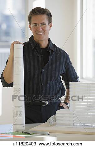 Portrait of architect with blueprint and building model View Large Photo Image Stock Image - Portrait of architect with blueprint and building model. Fotosearch