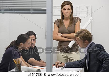Portrait of architect with blueprints working with team View Large Photo Image Stock Photo - Portrait of architect with blueprints working with team. Fotosearch