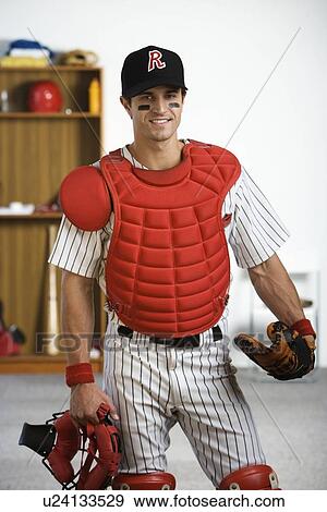 Portrait of baseball catcher in locker room View Large Photo Image Stock Photo - Portrait of baseball catcher in locker room. Fotosearch