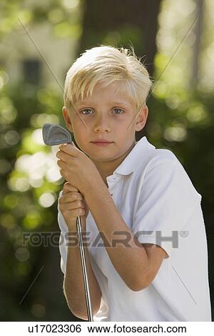 Stock Photograph - Portrait of boy with golf club. Fotosearch