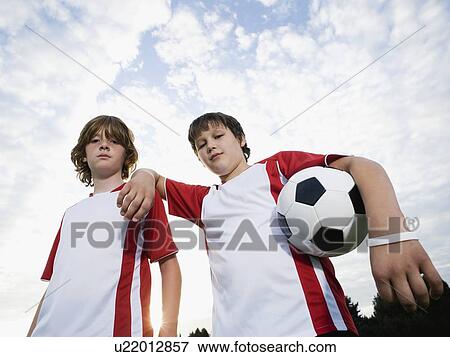 Portrait of boys in soccer uniforms holding ball View Large Photo Image Stock Photo - Portrait of boys in soccer uniforms holding ball. Fotosearch