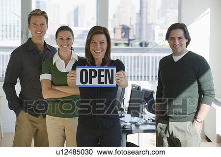 Portrait of business people holding ”Open” sign View Large Photo Image Stock Image - Portrait of business people holding ”Open” sign. Fotosearch