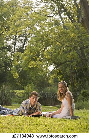 Portrait of college students studying in grass View Large Photo Image Stock Photo - Portrait of college students studying in grass. Fotosearch