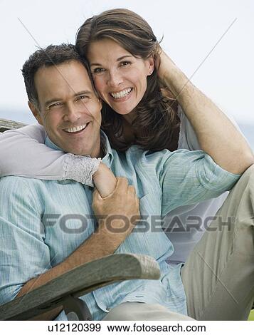 Stock Photo - Portrait of couple hugging. Fotosearch