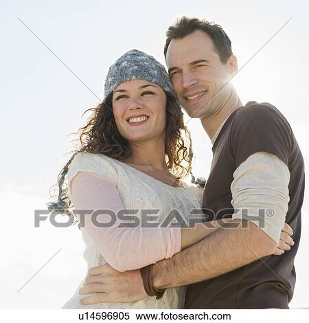 Stock Photography - Portrait of couple hugging. Fotosearch