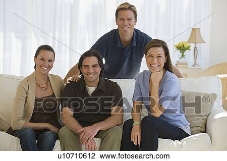 Portrait of couples sitting on sofa View Large Photo Image Stock Image - Portrait of couples sitting on sofa. Fotosearch