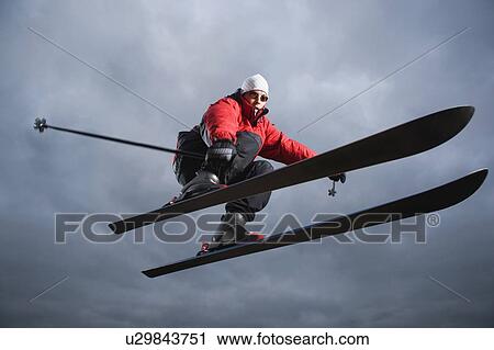 Portrait of downhill skier in mid-air View Large Photo Image Stock Image - Portrait of downhill skier in mid-air. Fotosearch