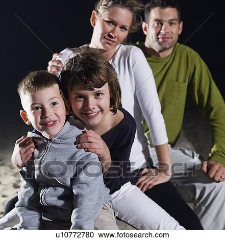Stock Image - Portrait of family on beach. Fotosearch
