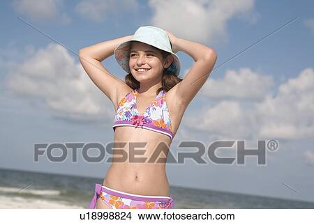 Portrait of girl on beach with hands behind head View Large Photo Image Picture - Portrait of girl on beach with hands behind head. Fotosearch