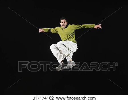 Stock Image - Portrait of man in mid-air. Fotosearch