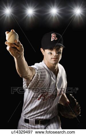Stock Photo - Portrait of pitcher throwing baseball. Fotosearch